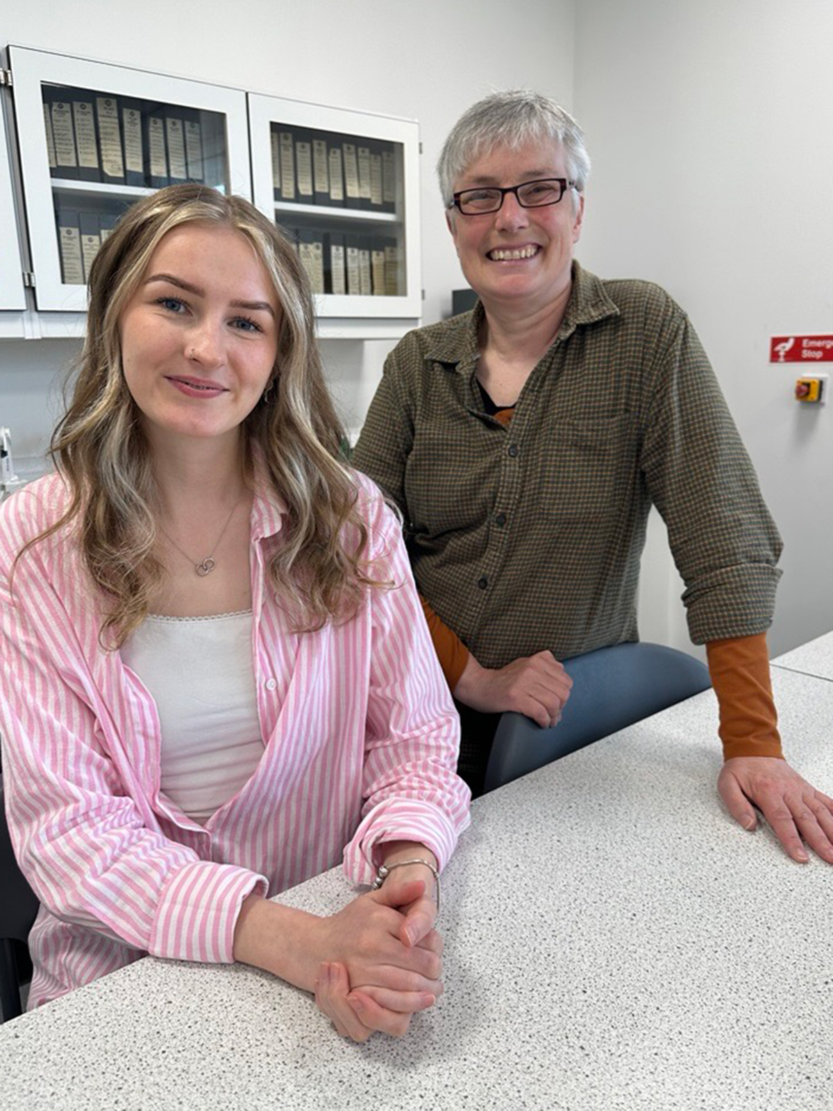 student and lecturer in a lab student and lecturer in a lab
