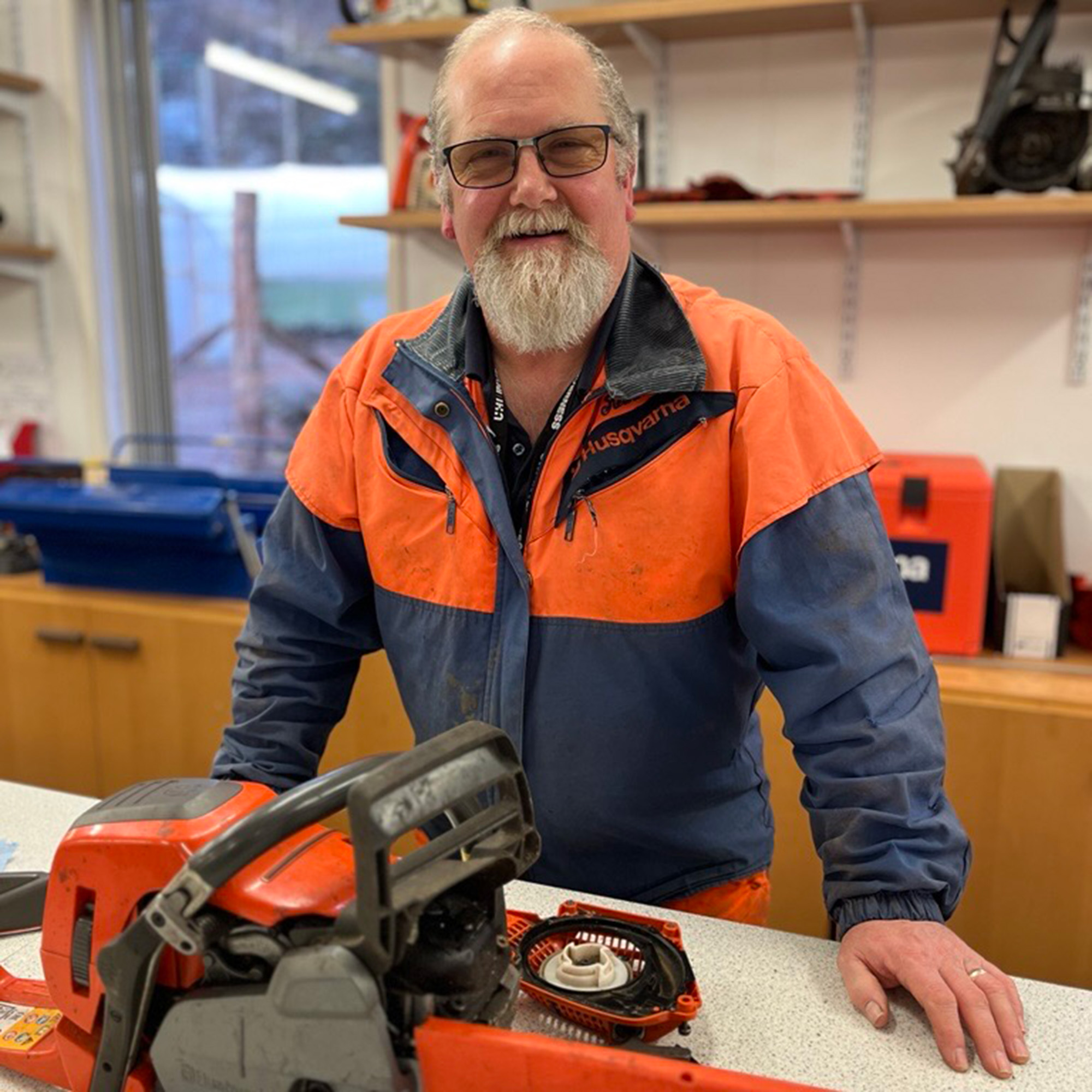 Neil Stewart in classroom with chainsaws