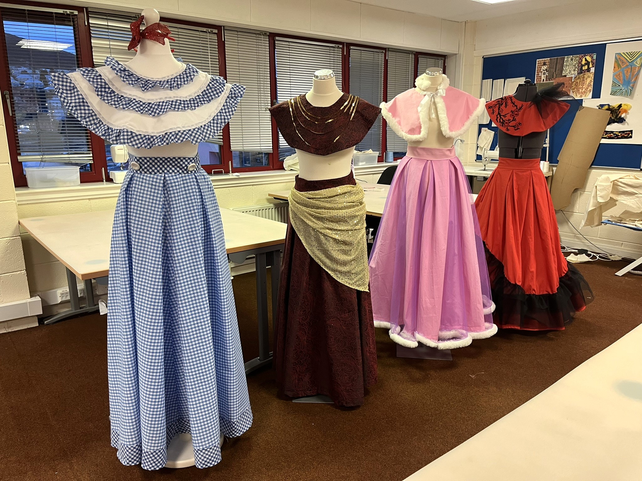 4 mannequins wearing costumes created by our Fashion and Textiles students for the musical, Cinderella.