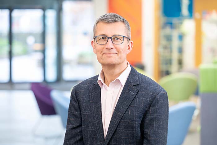 John Maher, Director of Physical and Digital Infrastructure, in business attire photographed at An Lochran