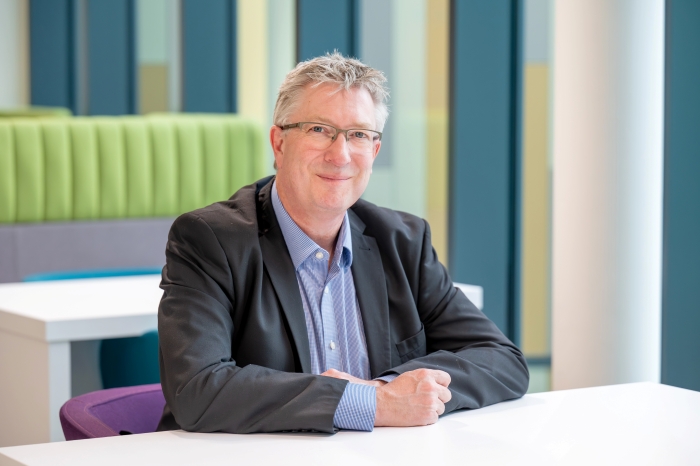 Mike Baxter sitting at a table Mike Baxter sitting at a table