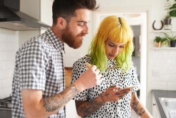 Two people looking at a phone