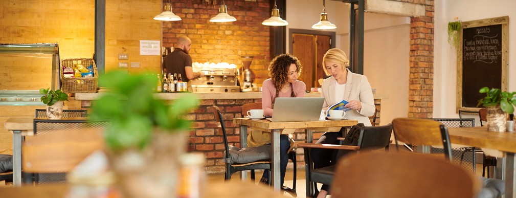 two women sitting at a computer two women sitting at a computer