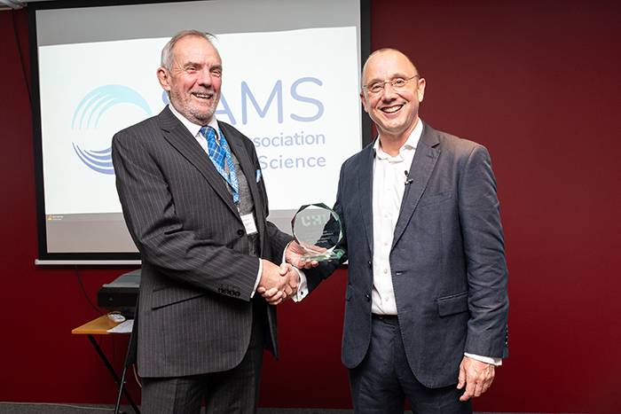 Professor Nick Owens, Director of SAMS, handing Adam Hughes, Professor of Innovation in the Blue Economy, a glass award. Photo credit: SAMS and UHI Professor Nick Owens, Director of SAMS, handing Adam Hughes, Professor of Innovation in the Blue Economy, a glass award. Photo credit: SAMS and UHI
