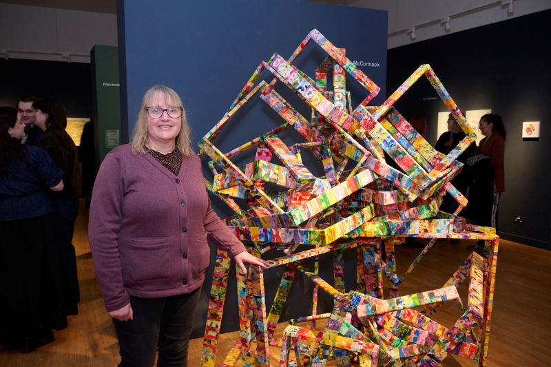 Jan McCormack standing in front of artwork