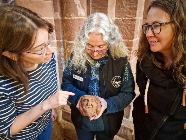The UHI Archaeology Institute’s Dr Sarah Jane Gibbon (left) and Dr Jen Harland discuss the Skaill head with St Magnus Cathedral curator Fran Flett Hollinrake. (Photo Dan Lee