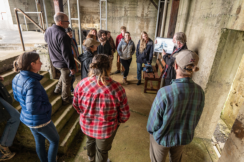 Group of people listening to a speaker at an archaeology site