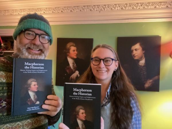 Mairi and Jim MacPherson holding their new book, MacPherson the Historian