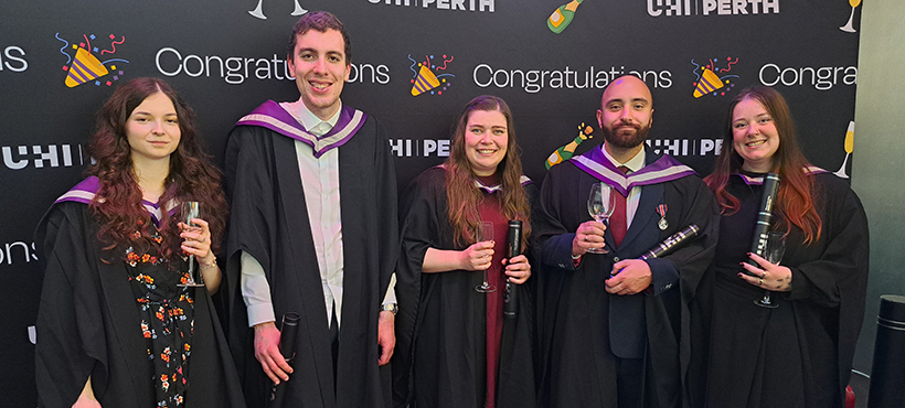 UHI Perth graduates posing in gowns