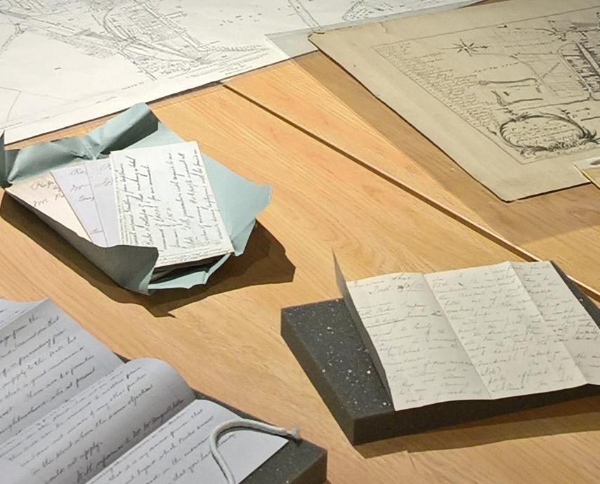 Selection of maps and letters arranged on a table