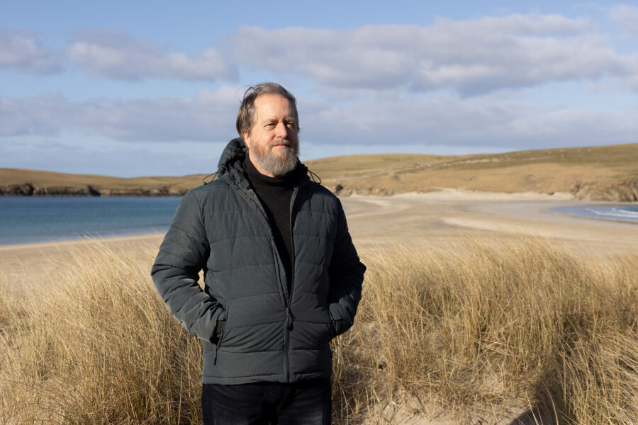 Photograph of Dr Andrew Jennings on a beach