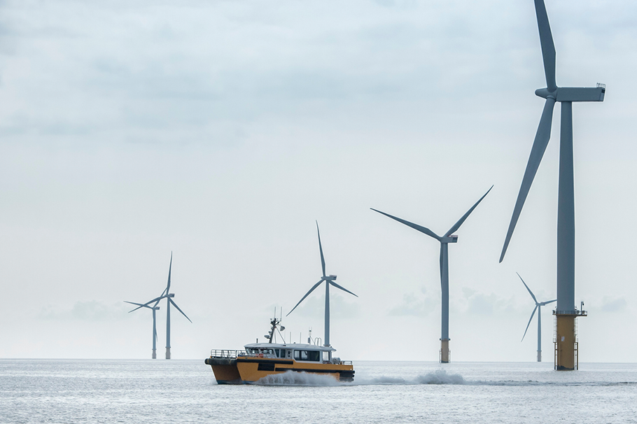 Boat sailing past an offshore windfarm
