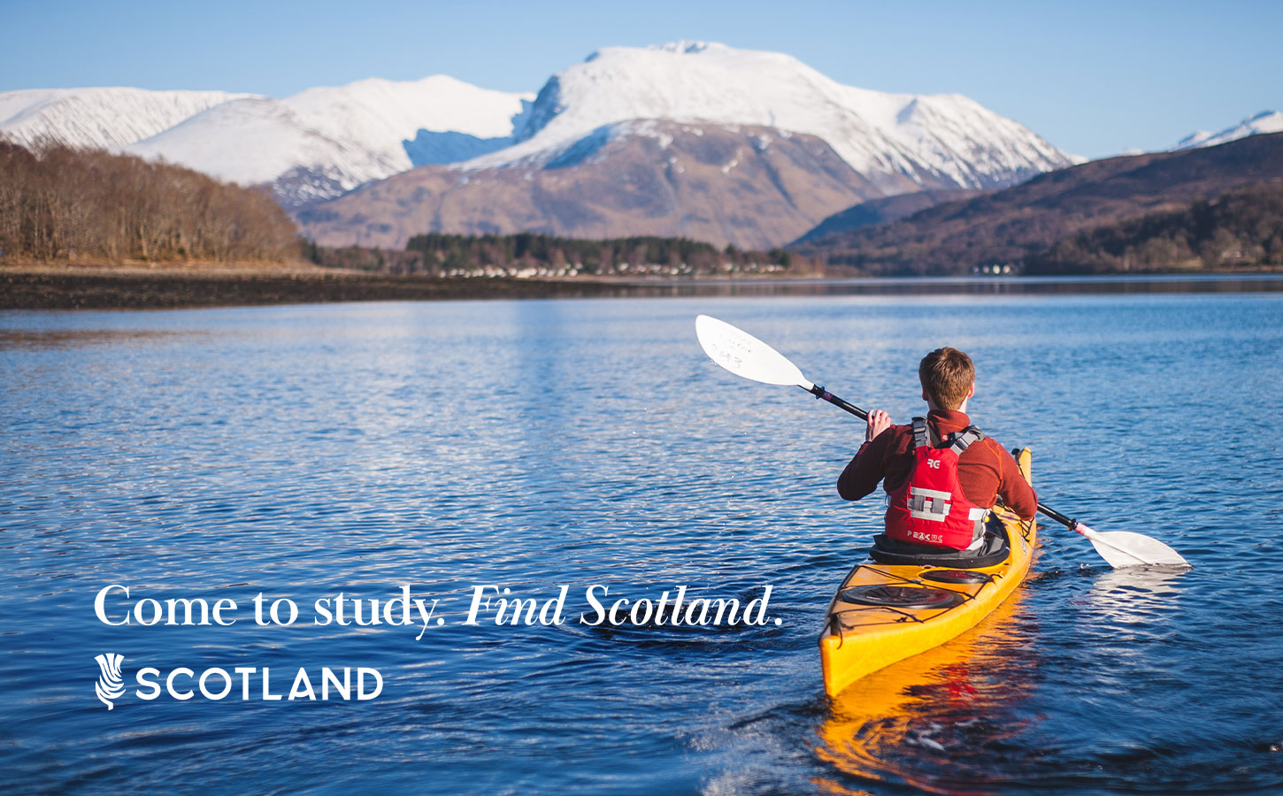 Student kayaking across Loch Eil towards Ben Nevis