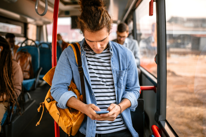 Person looking at their phone on a bus