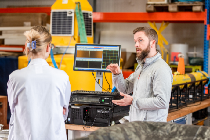 Student and a lecturer in a robotics laboratory