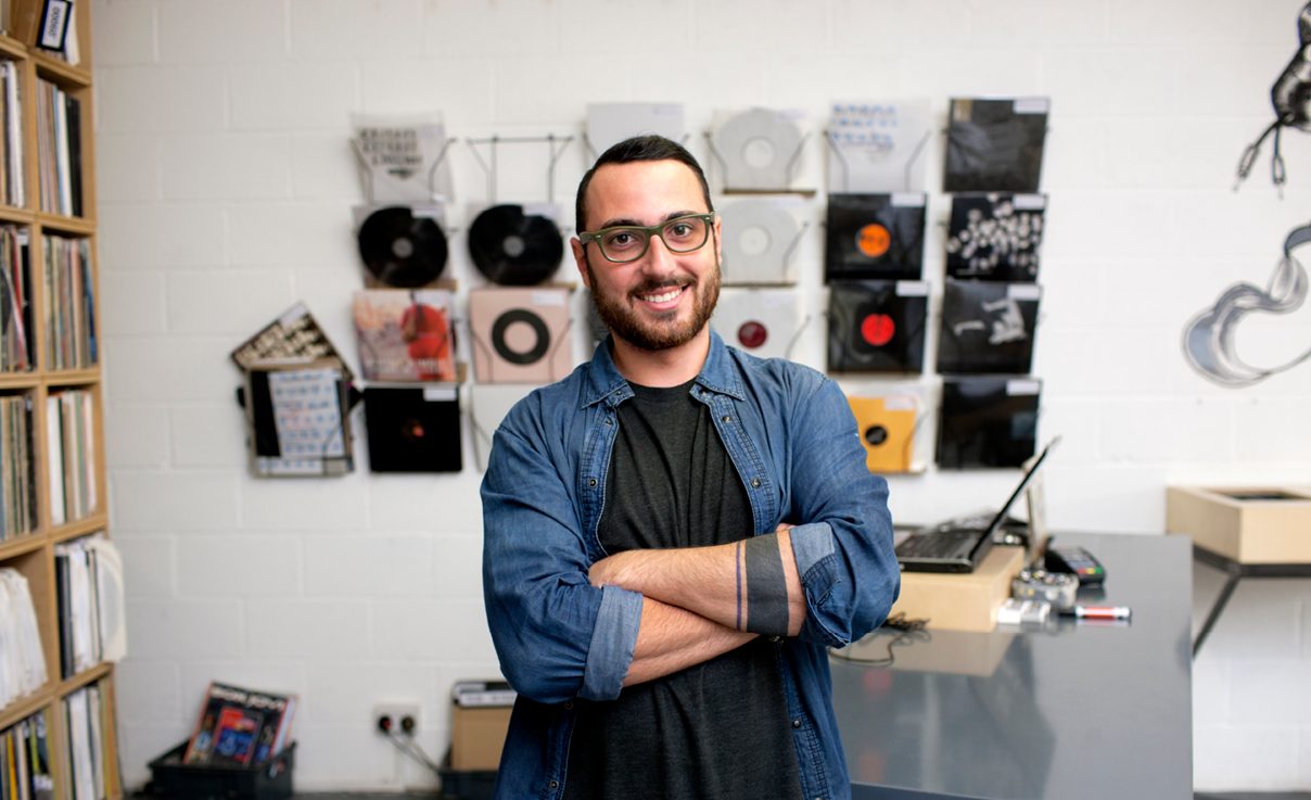 Man standing in front of music records